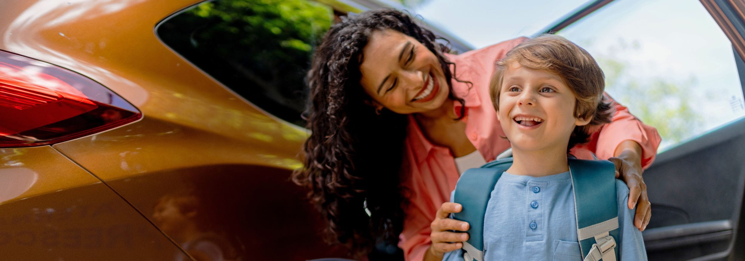 Woman and kid in front of car
