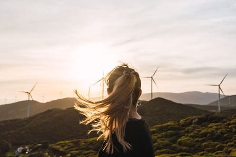 A girl looking at windmills