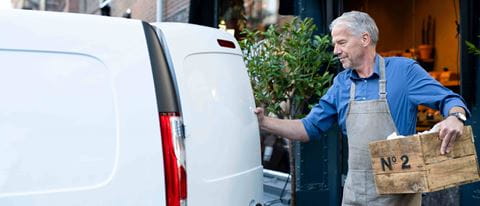 Bakery owner putting box in van