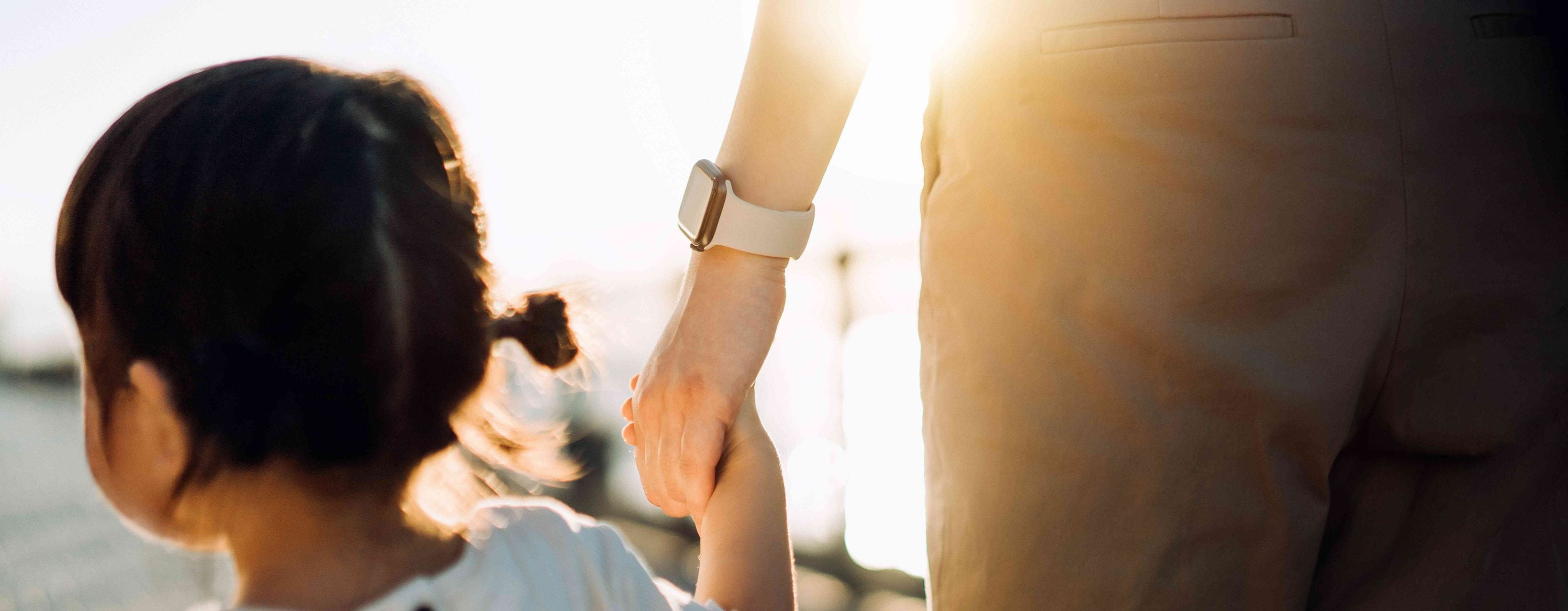 Child holding persons hand
