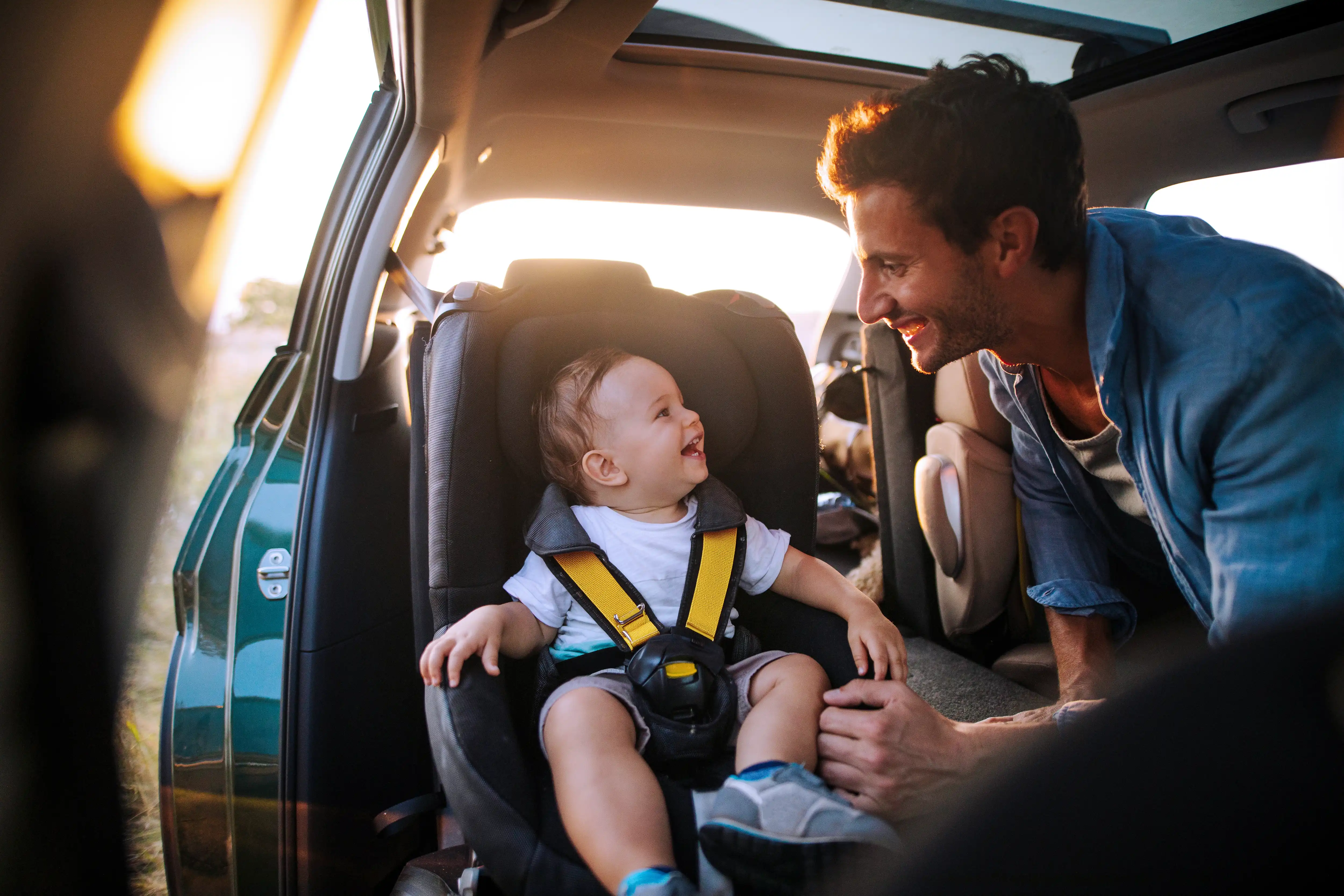 obviously_man with smiling kid in car seat
