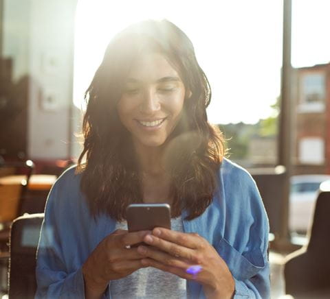 ZipperGirlinblueshirtlookingatphone2x 1