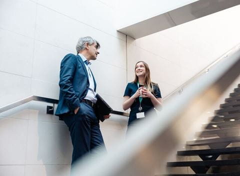 Small-Ayv_image_corporate_hallwaydiscussion
