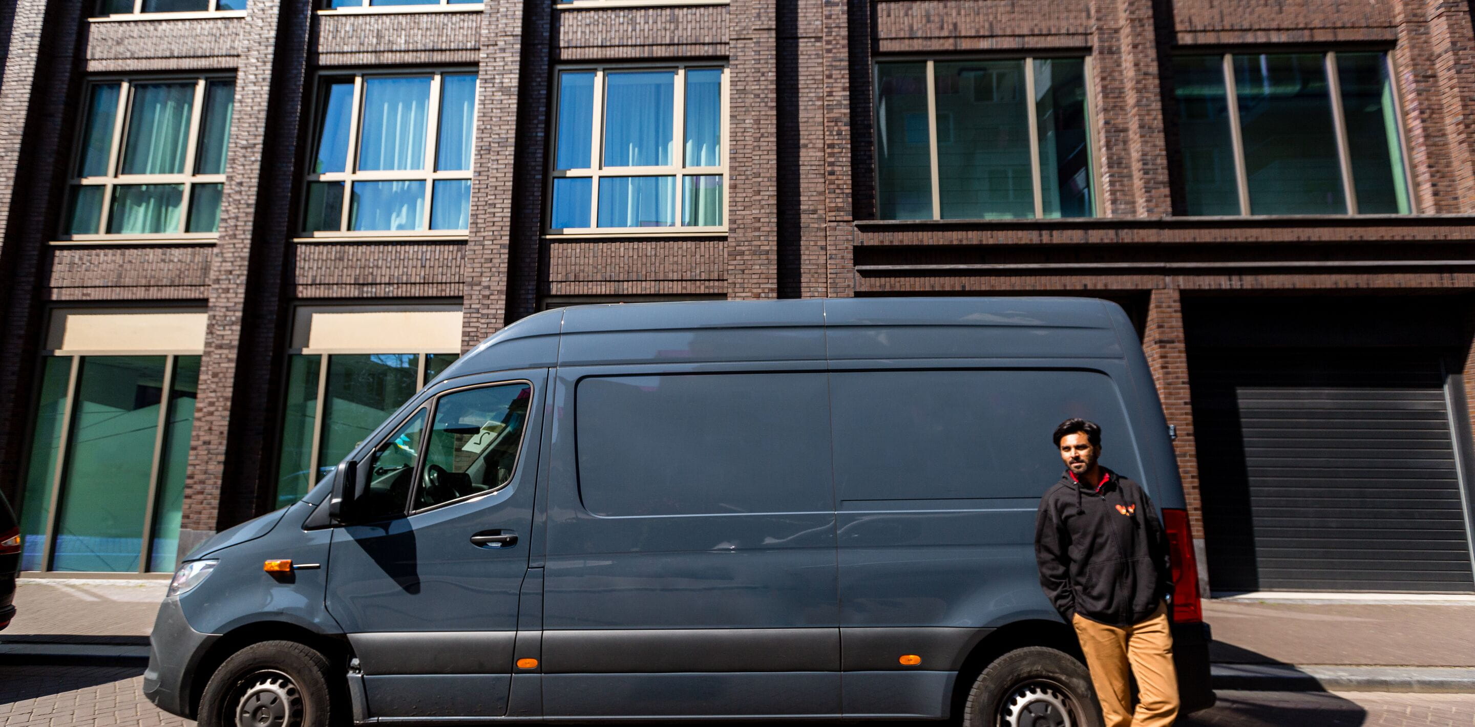 Man standing in front of grey van