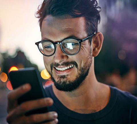 zipper-smiling-man-looking-at-his-phone